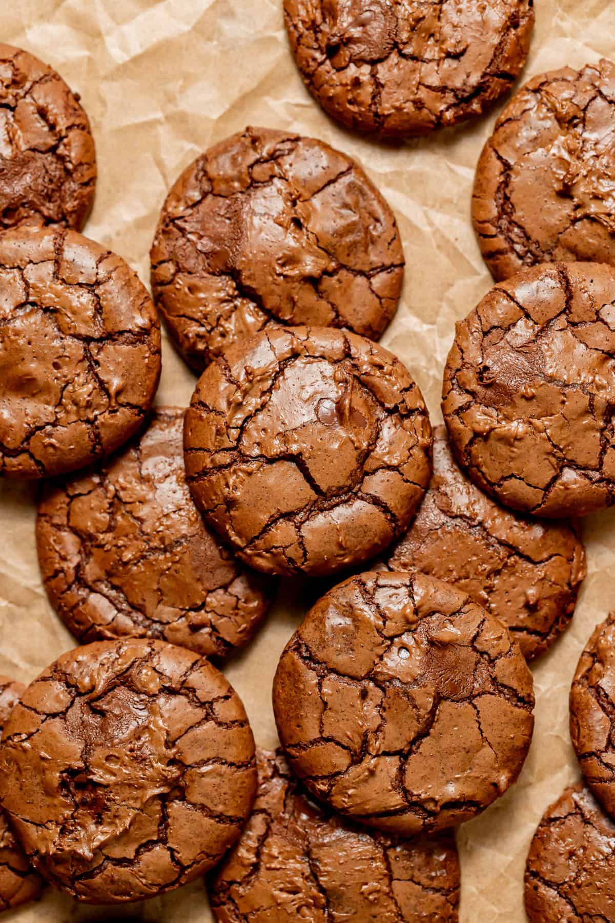 chocolate Nutella cookies scattered on parchment paper.