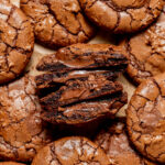 nutella cookies cut in half on parchment paper.