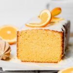 glazed orange pound cake with orange slices on top.