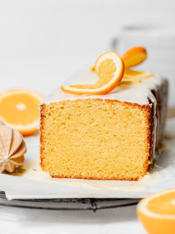 glazed orange pound cake with orange slices on top.