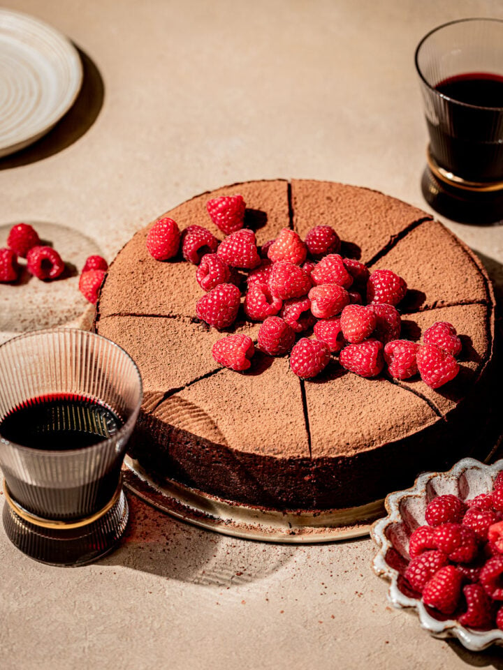 red wine chocolate cake with fresh raspberries on top.