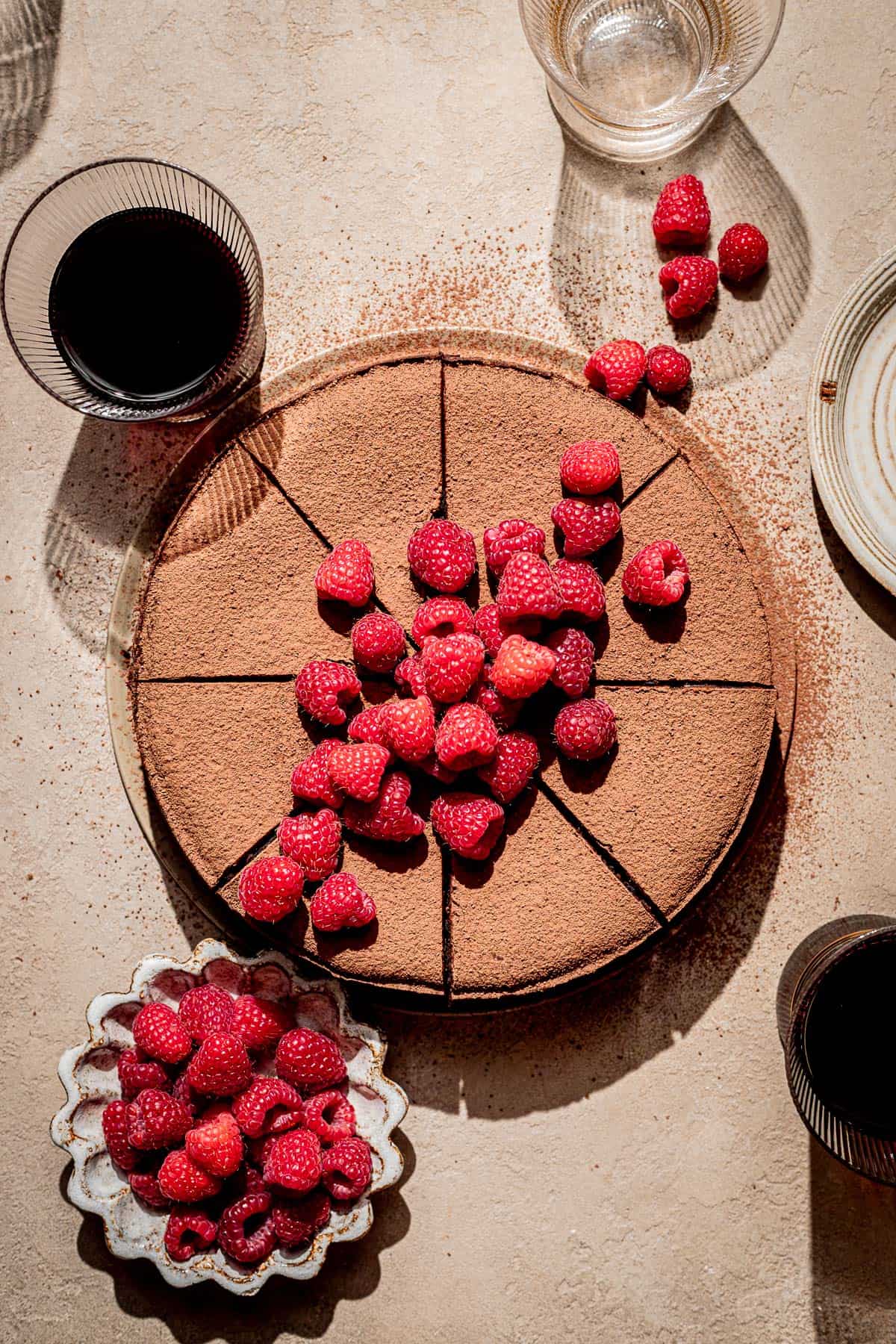 overhead shot of red wine chocolate cake with fresh raspberries on top.