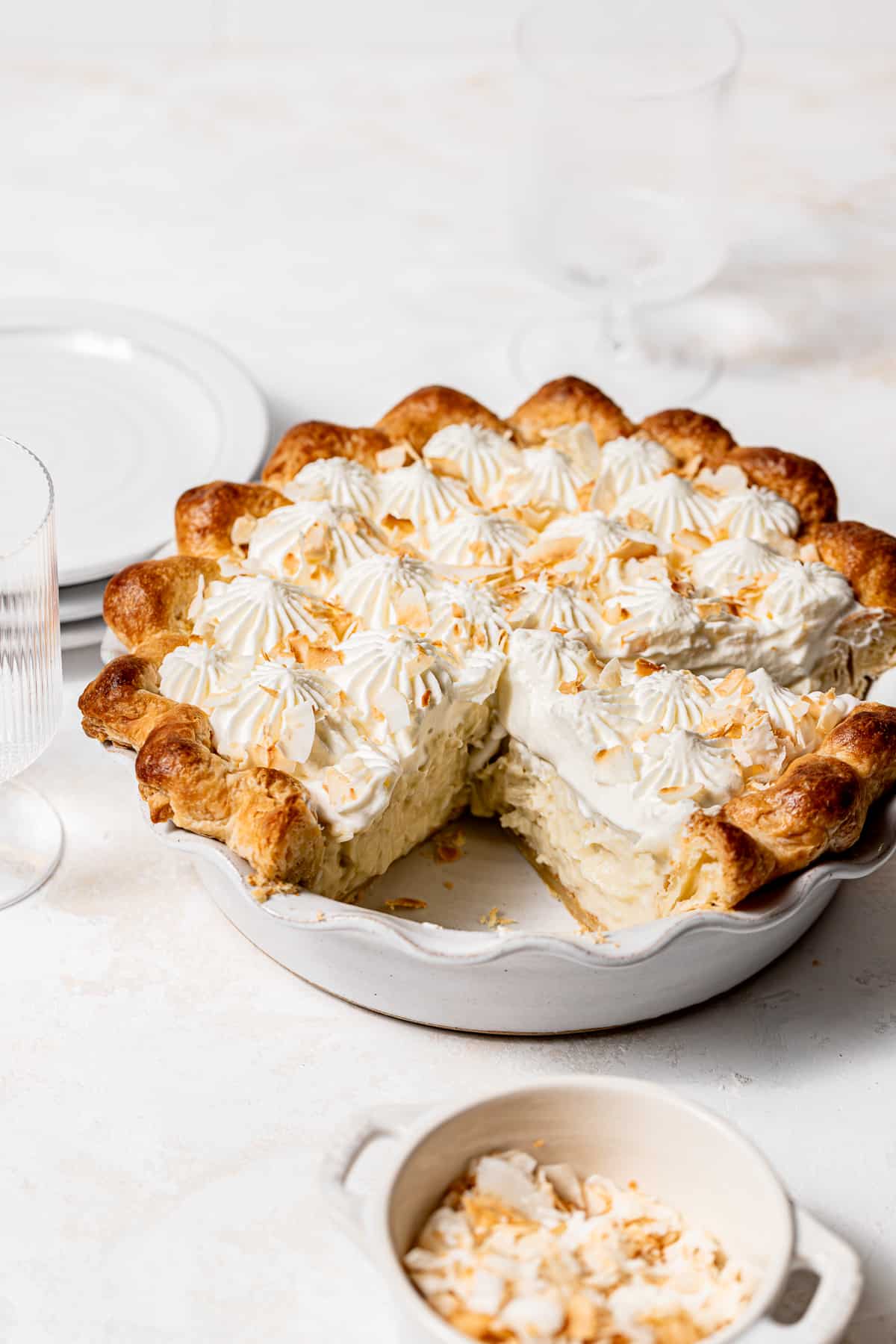 coconut cream pie in white pie dish.