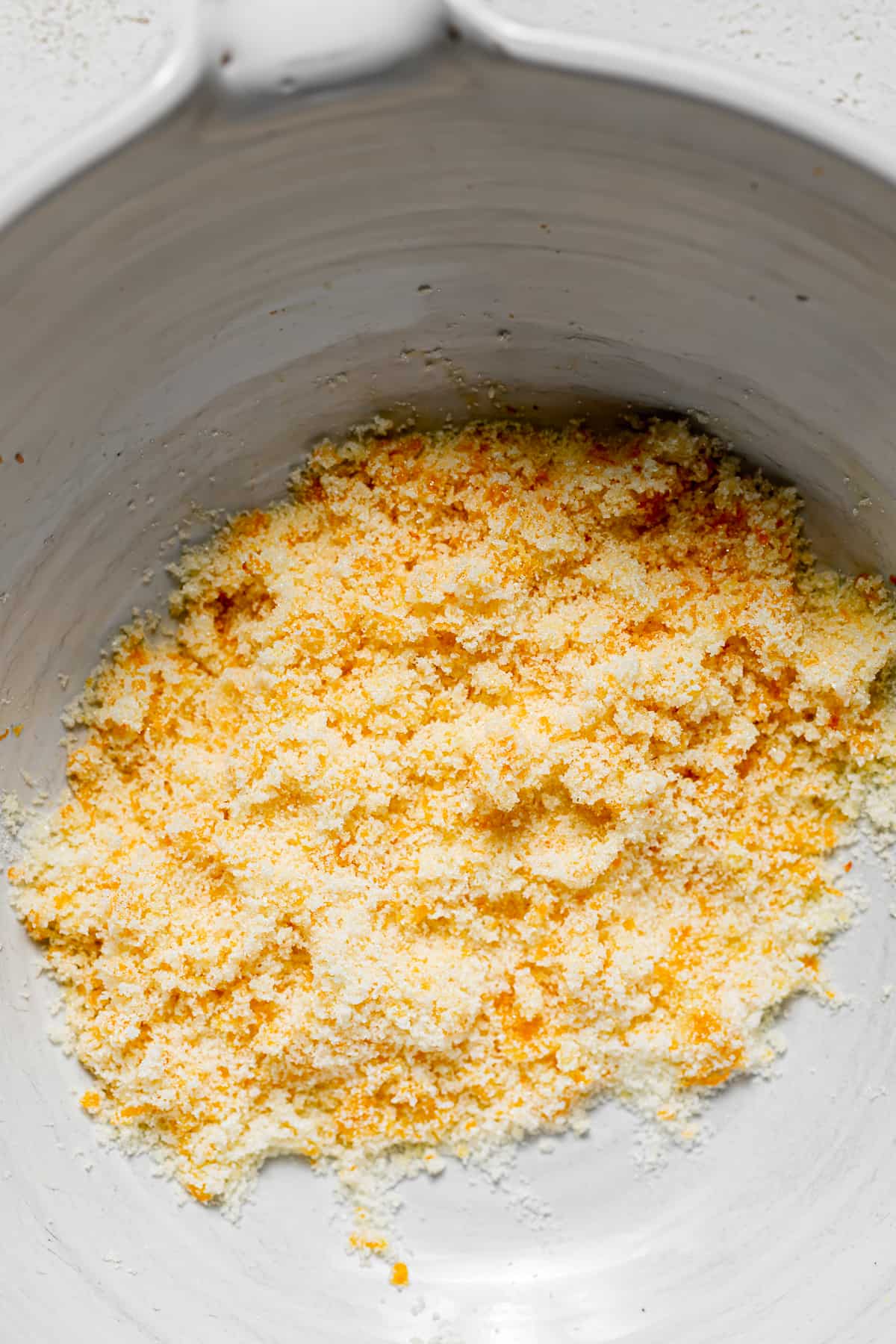 sugar and orange zest mixed in bowl.