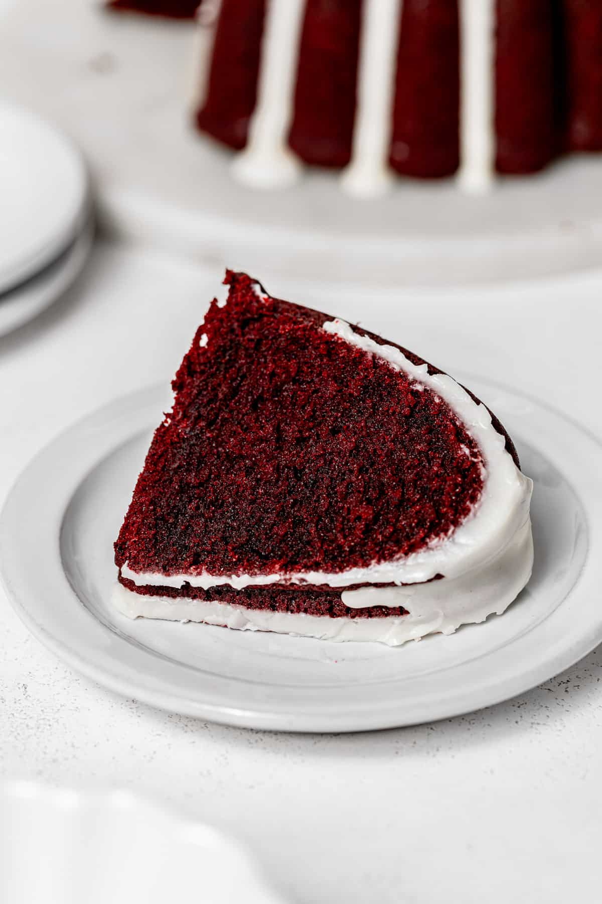 slice of red velvet bundt cake on white plate.