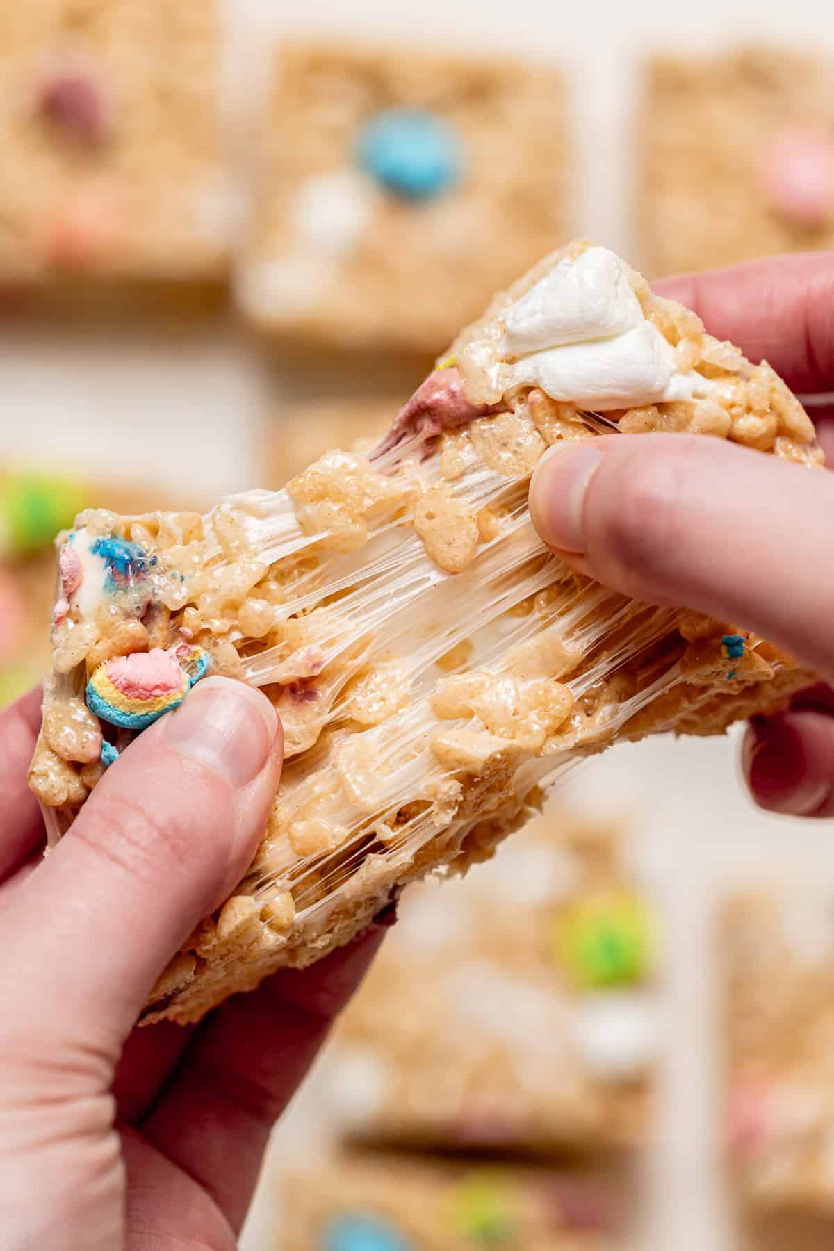 Lucky Charms Rice Krispie Treats square being pulled apart.