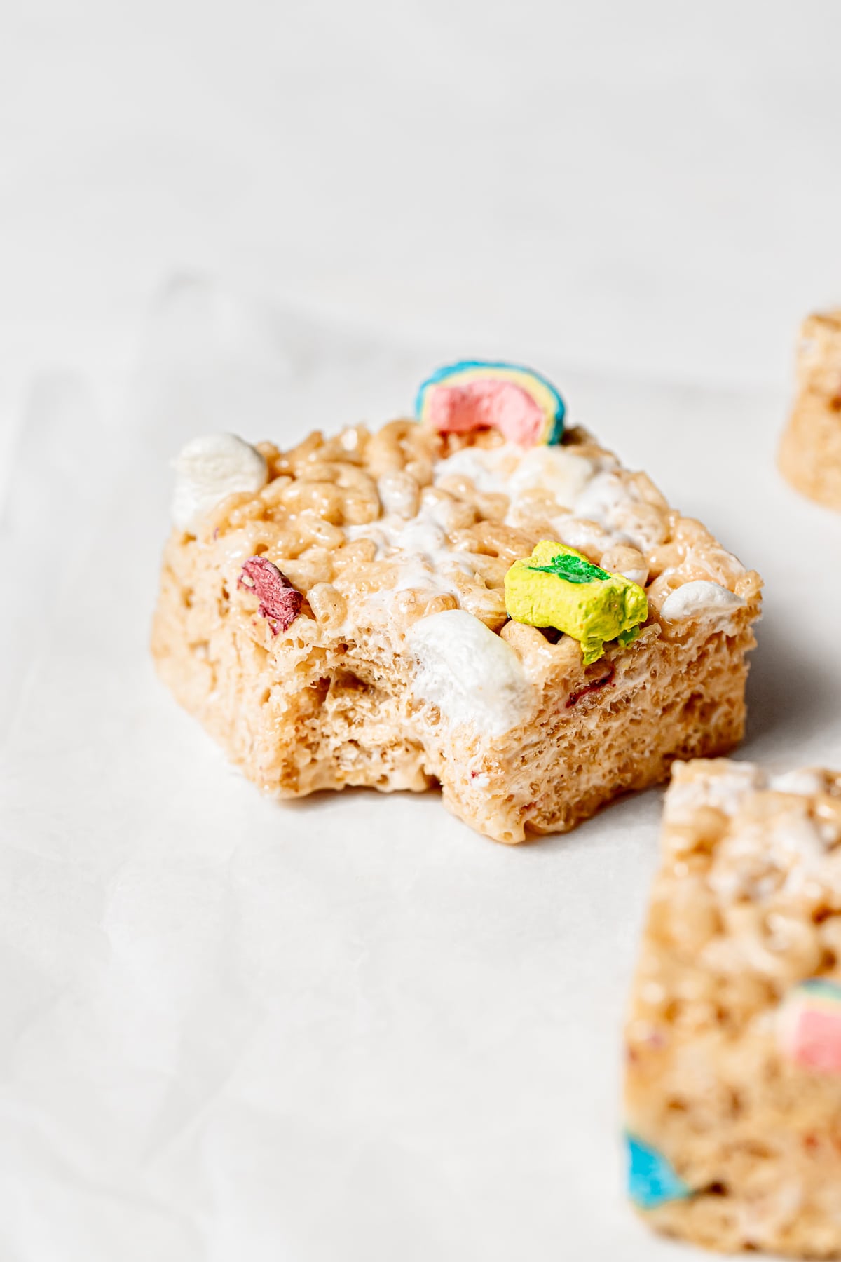 Lucky Charms Rice Krispie Treats square with small bite taken out.