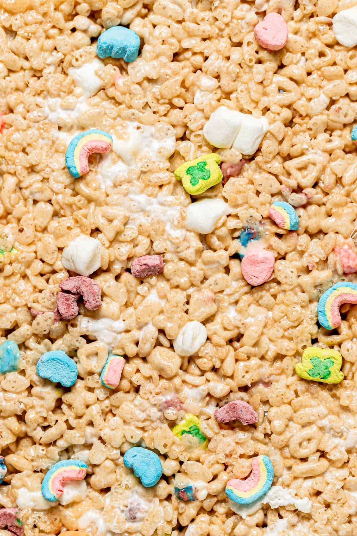 close up of Lucky Charms Rice Krispie Treats spread into pan.