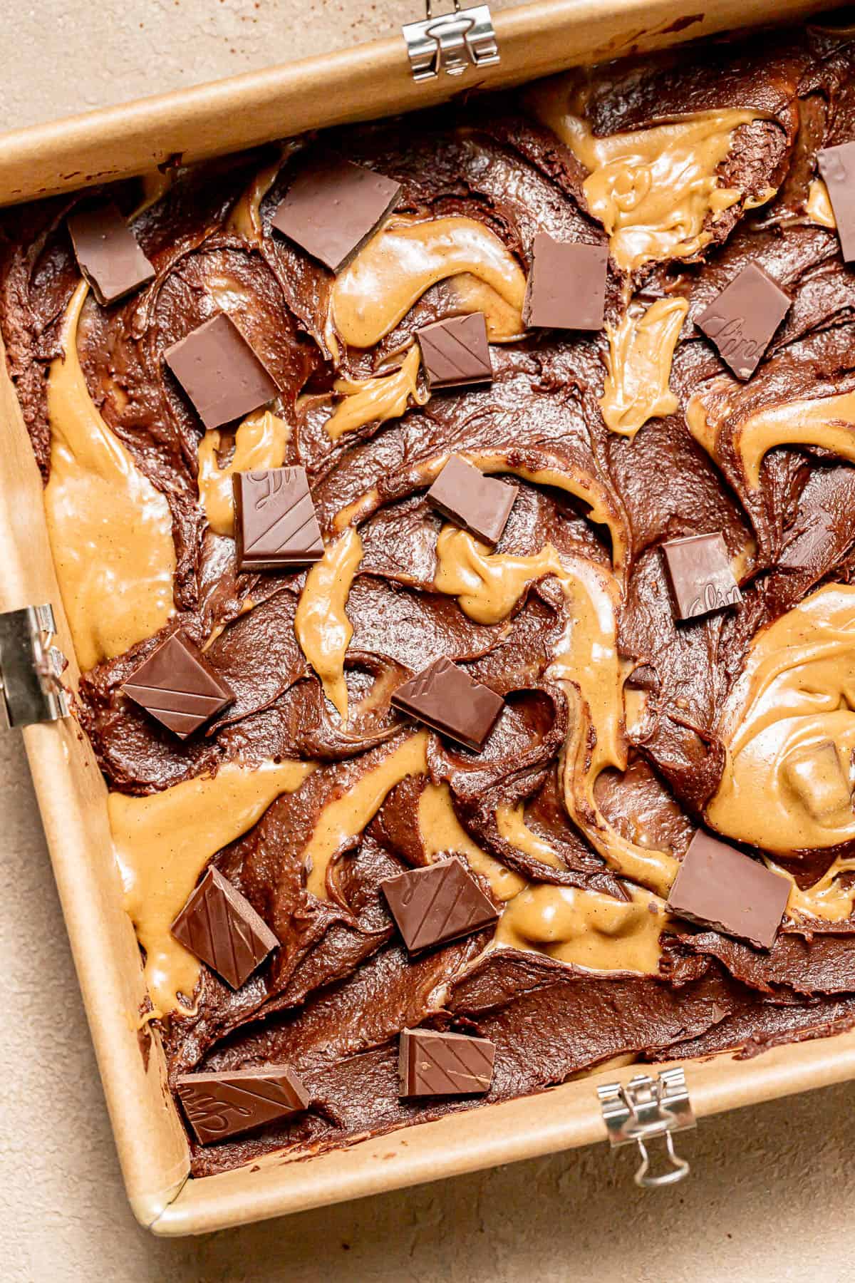 brownie and blondie batters swirled in square pan.