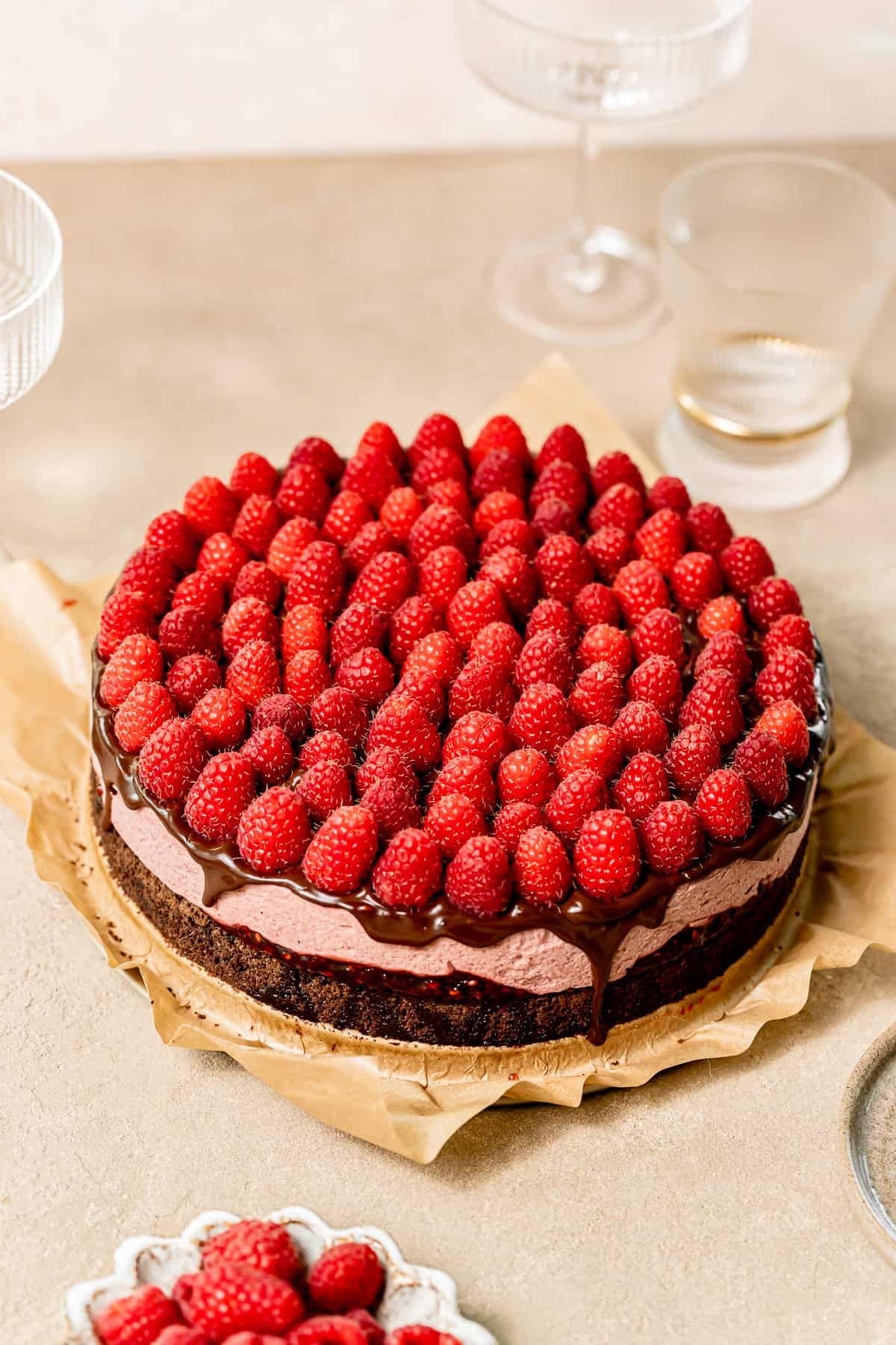 chocolate raspberry mousse cake with fresh raspberries on top.