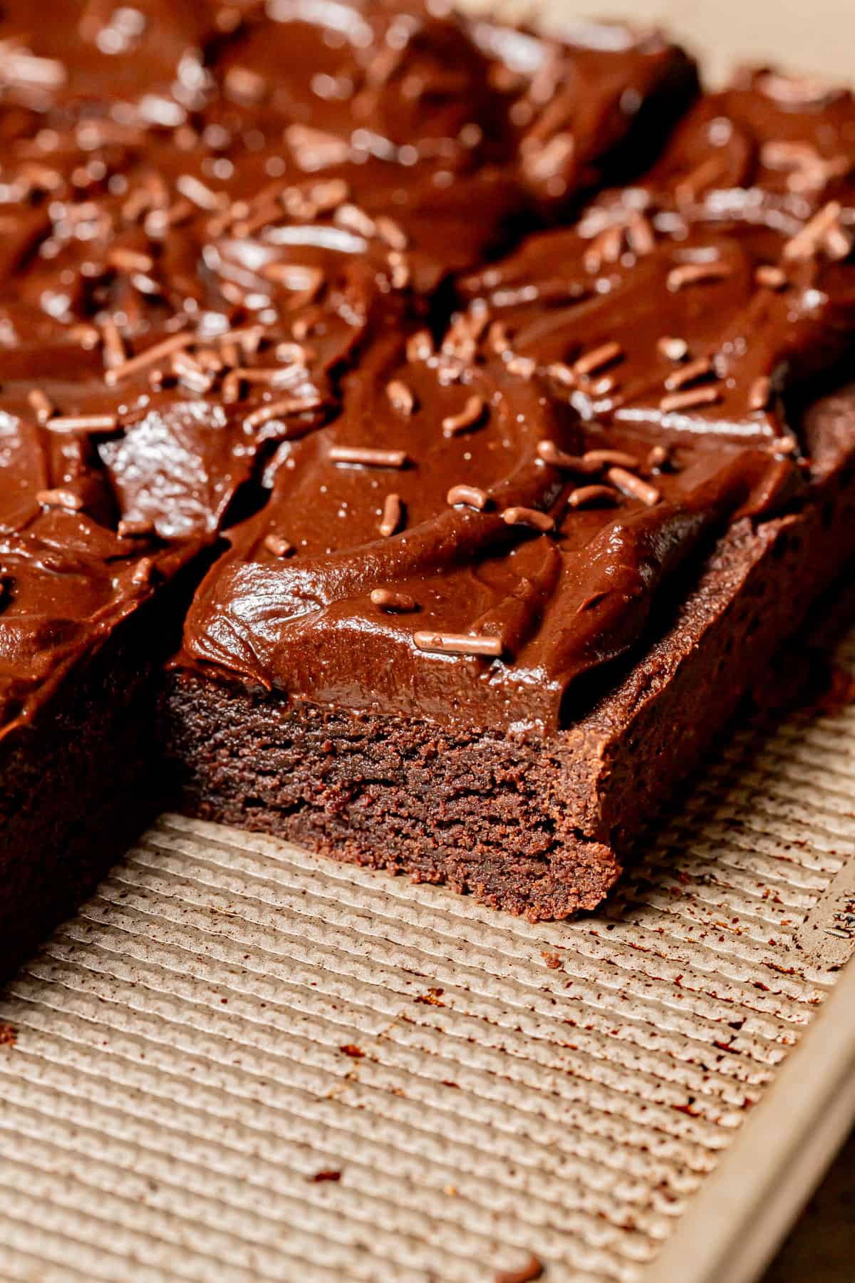 Chocolate Sugar Cookie Bars cut into squares on baking sheet.