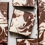 peppermint bark brownies on parchment paper.