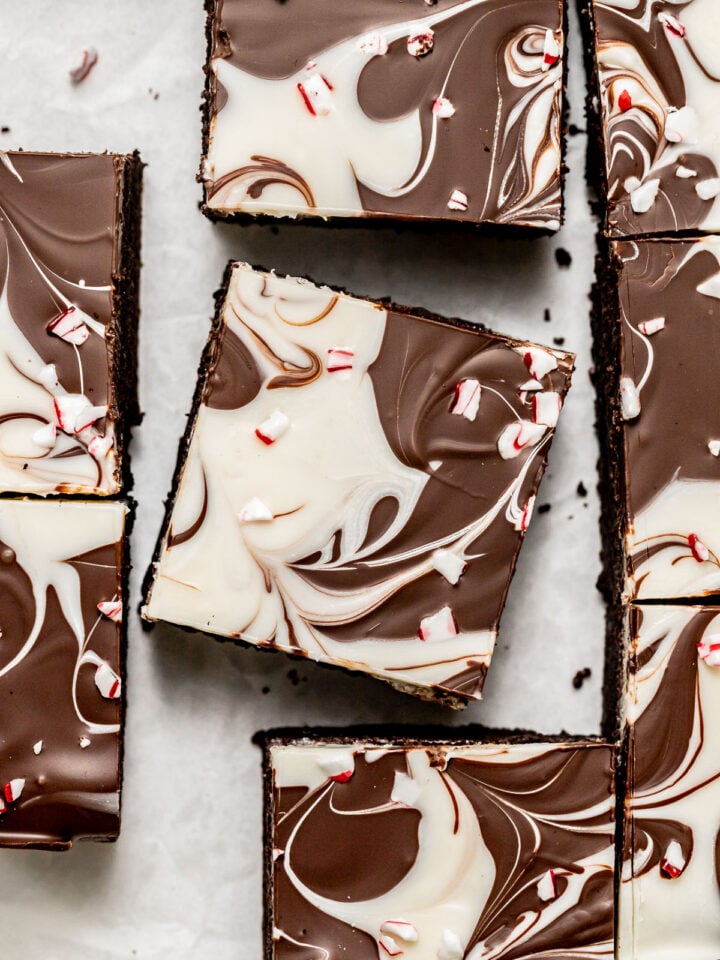 peppermint bark brownies on parchment paper.