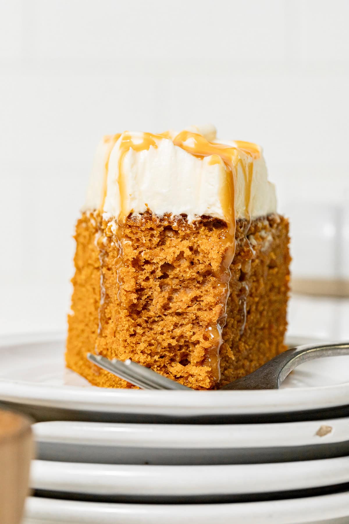 slice of Salted Caramel Pumpkin Cake on stacked plates.