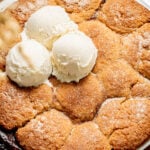 apple cobbler with ice cream scoops on top.