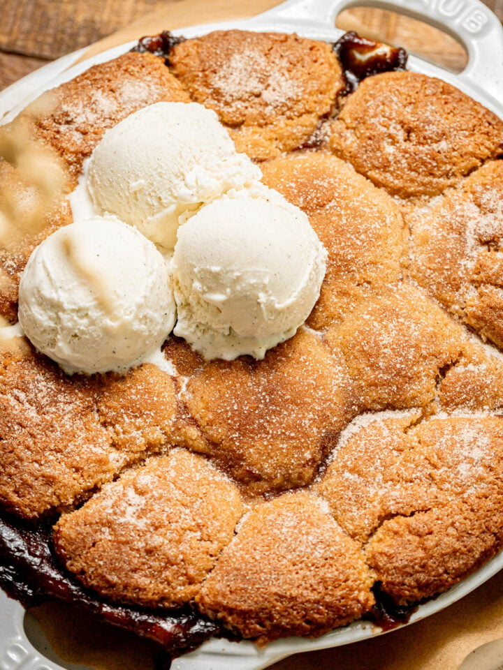 apple cobbler with ice cream scoops on top.