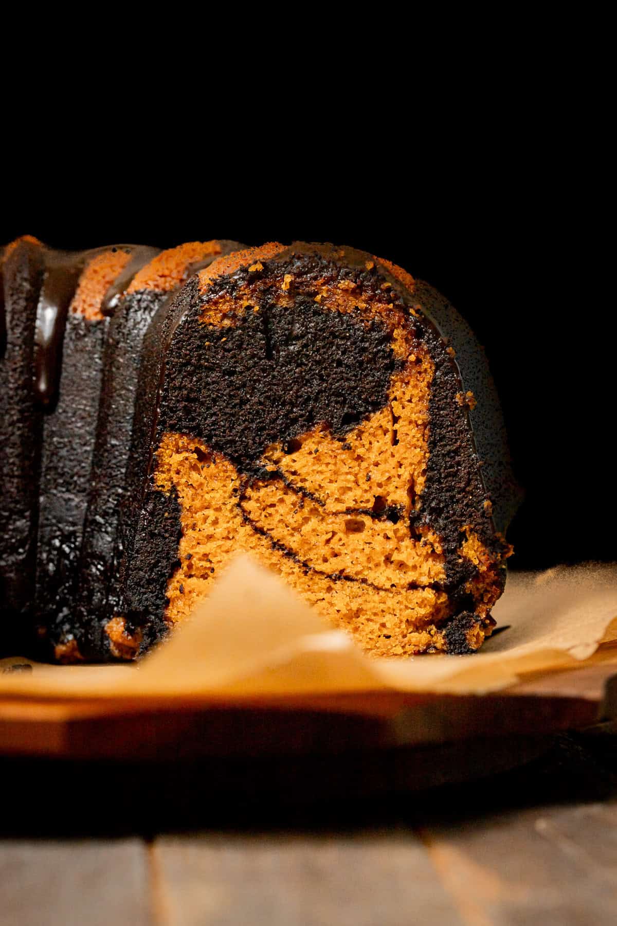 chocolate pumpkin cake cut to show inside swirl.