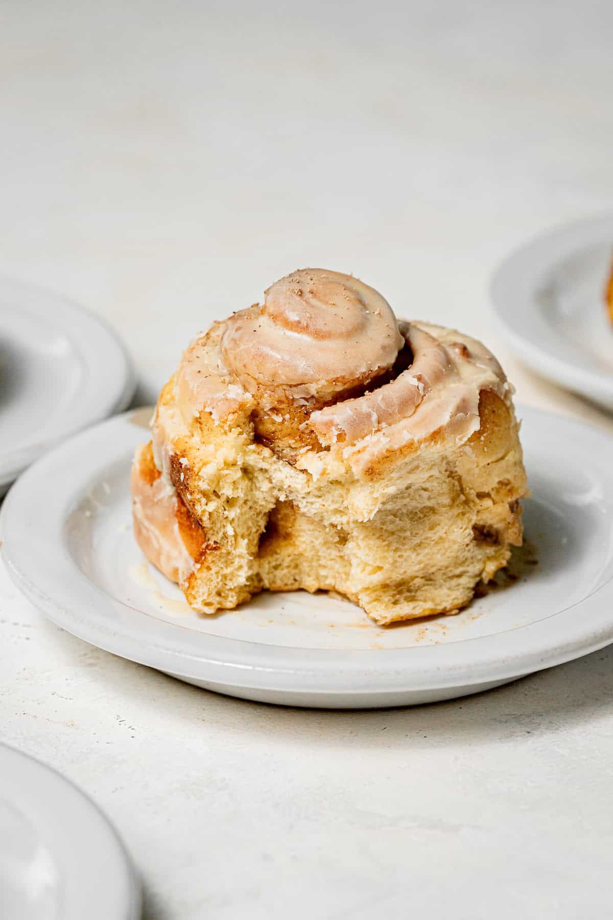 one Eggnog Cinnamon Roll on plate.