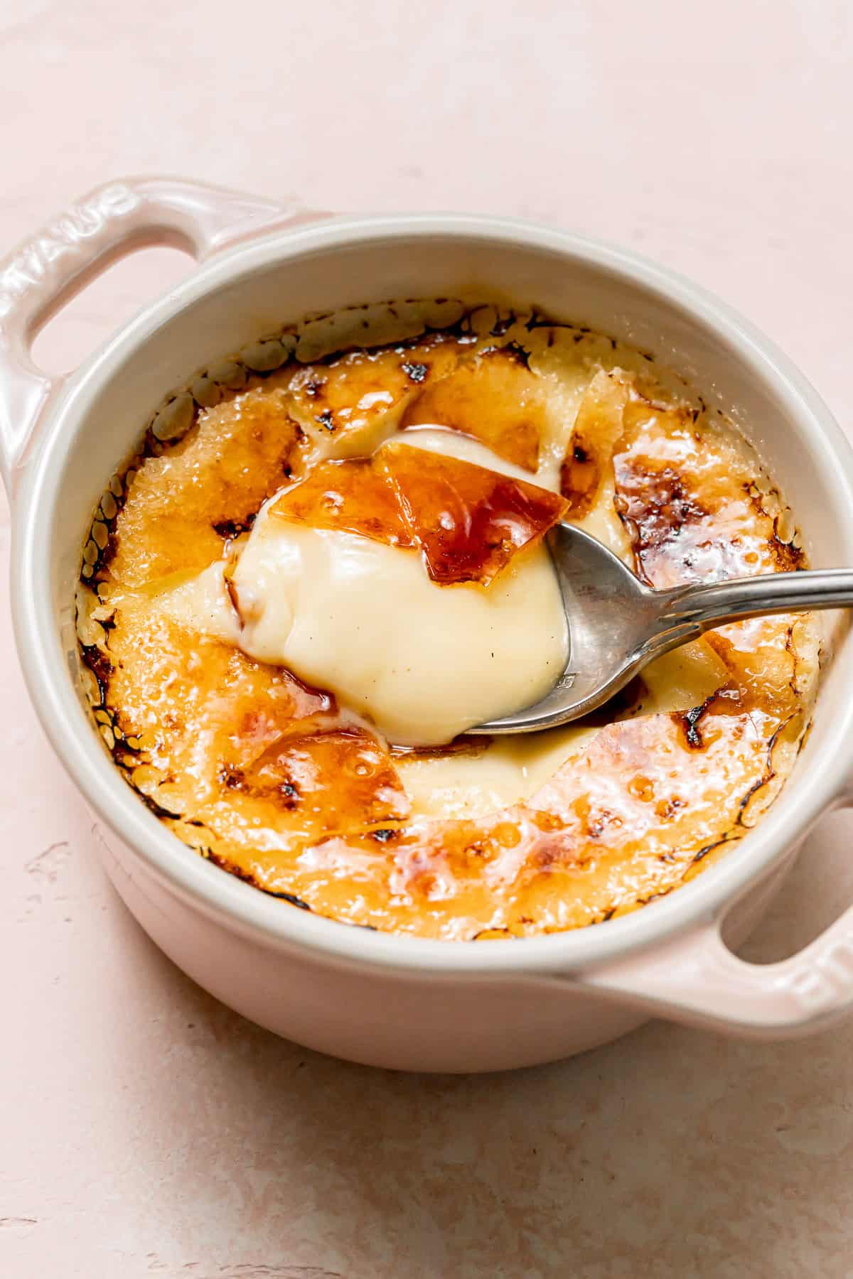 Single Serve Crème Brûlée in moni cocotte with spoon.