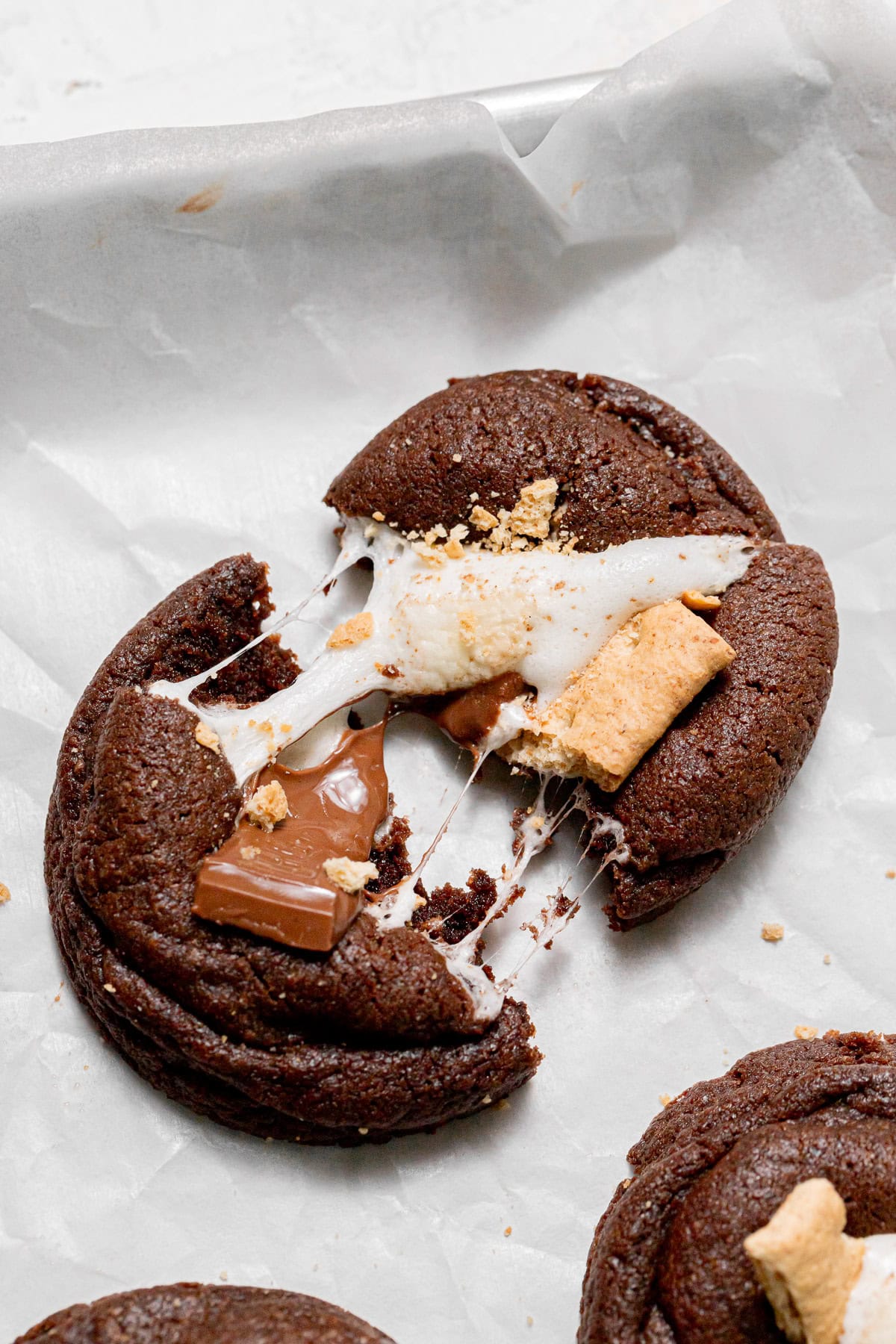 cookie pulled apart on parchment paper.