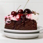 slice of black forest cake on stacked plates.