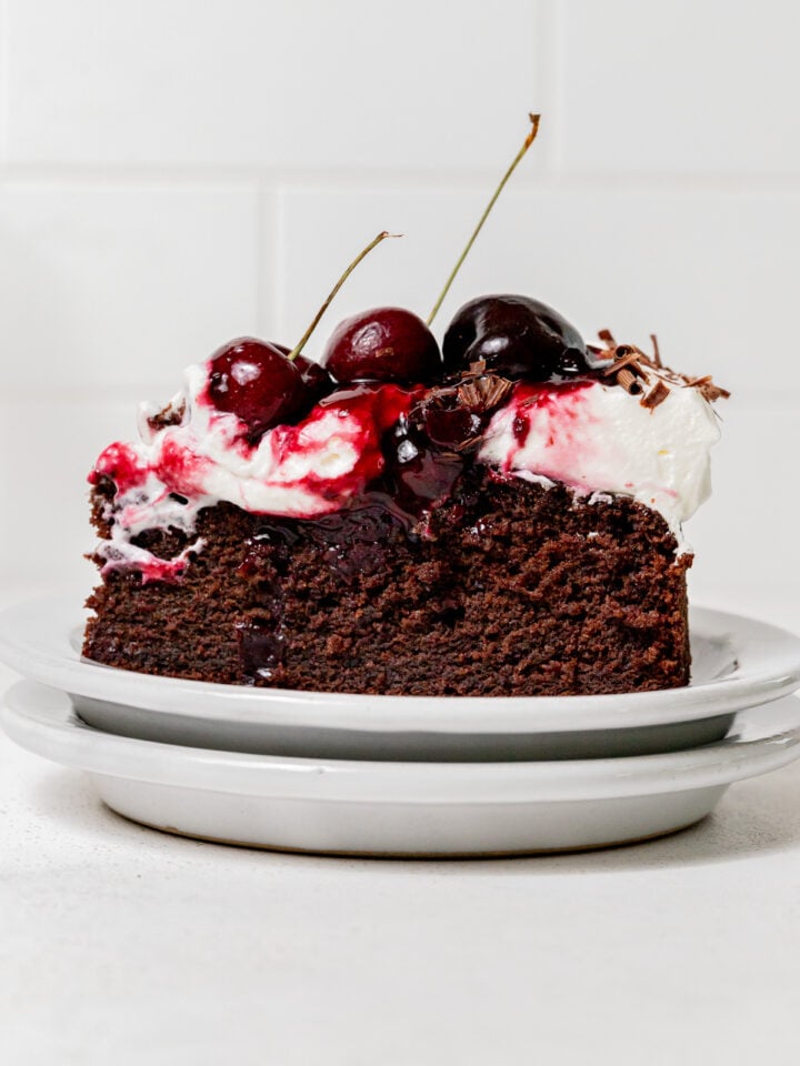 slice of black forest cake on stacked plates.