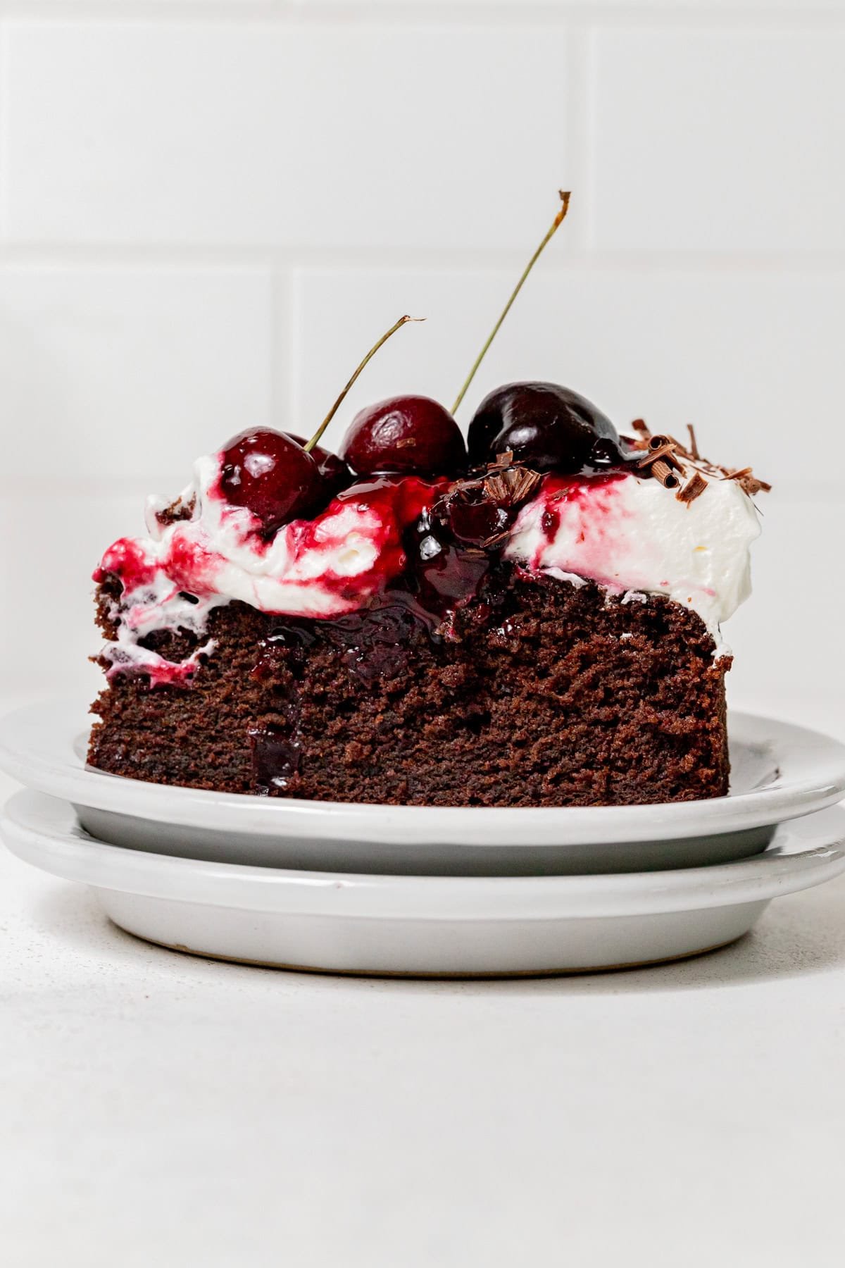 slice of black forest cake on stacked plates.
