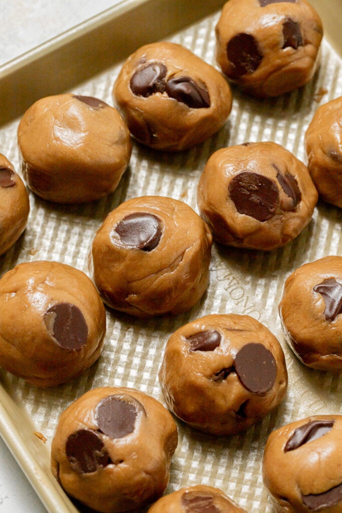 cookie dough balls on baking sheet.