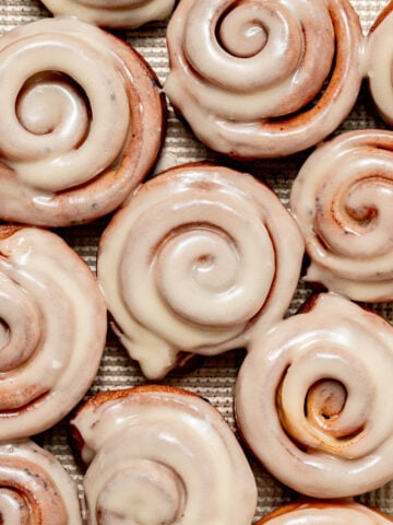 cinnamon roll donuts on baking sheet.