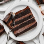 slices of dark chocolate mousse cake on plates.