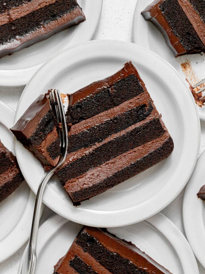 slices of dark chocolate mousse cake on plates.