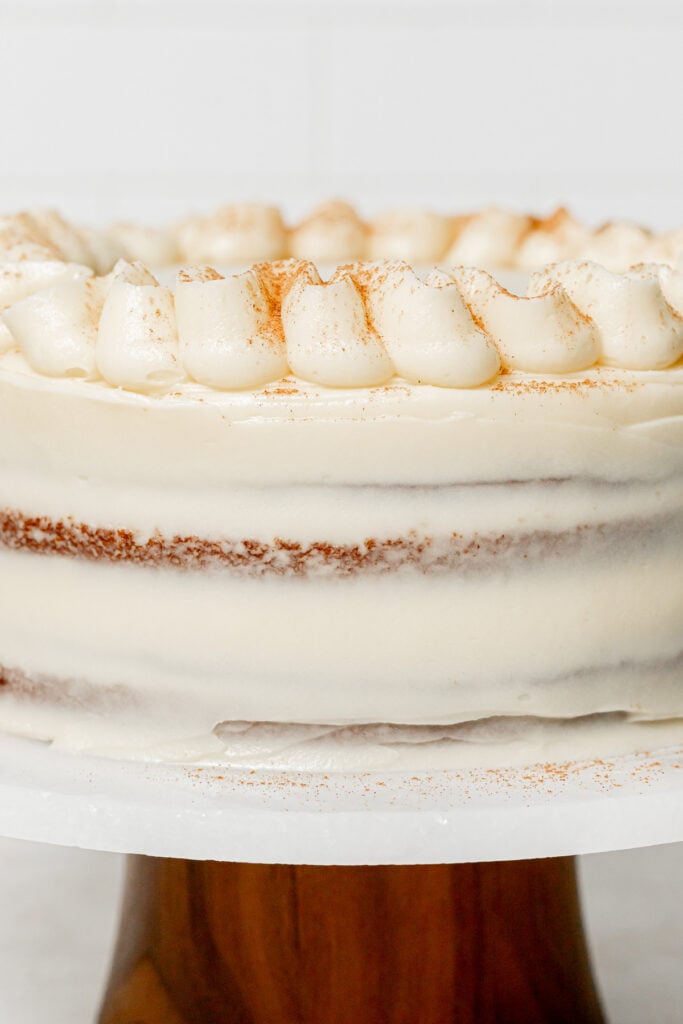 Pumpkin Cake with Cream Cheese Frosting decorated on cake stand.