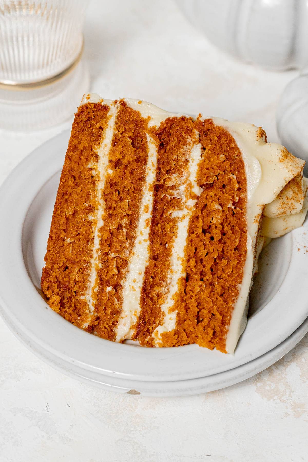 Pumpkin Cake with Cream Cheese Frosting slice on plate.