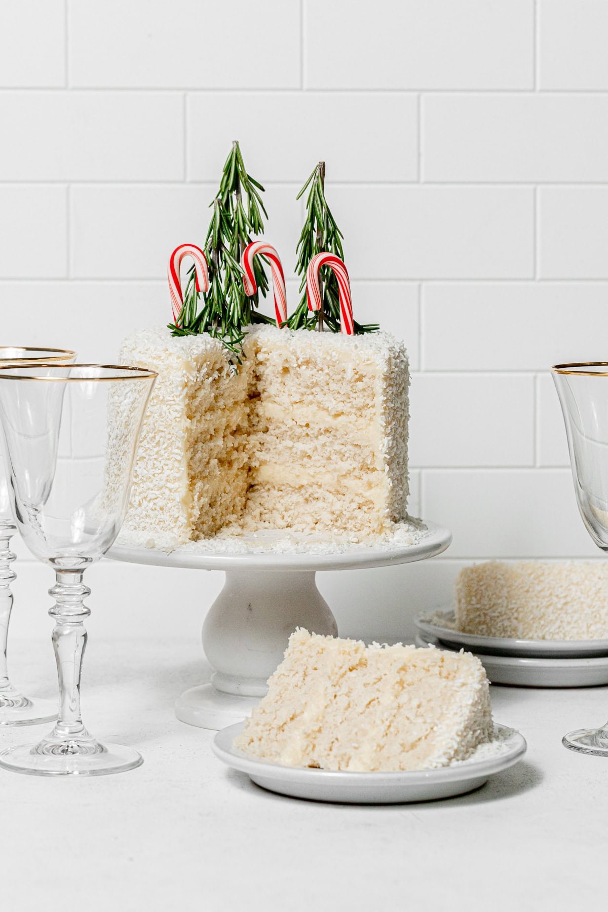 coconut snowball cake cut with slices on plates.