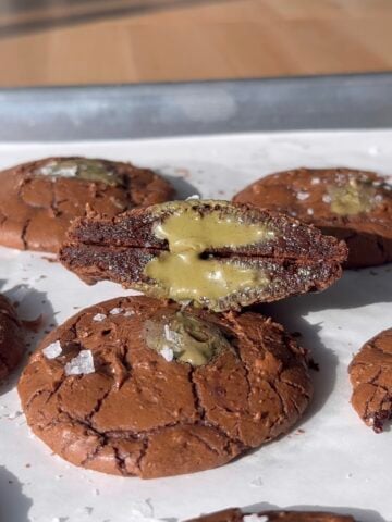 Pistachio Cream Stuffed Brownie Cookie cut in half.