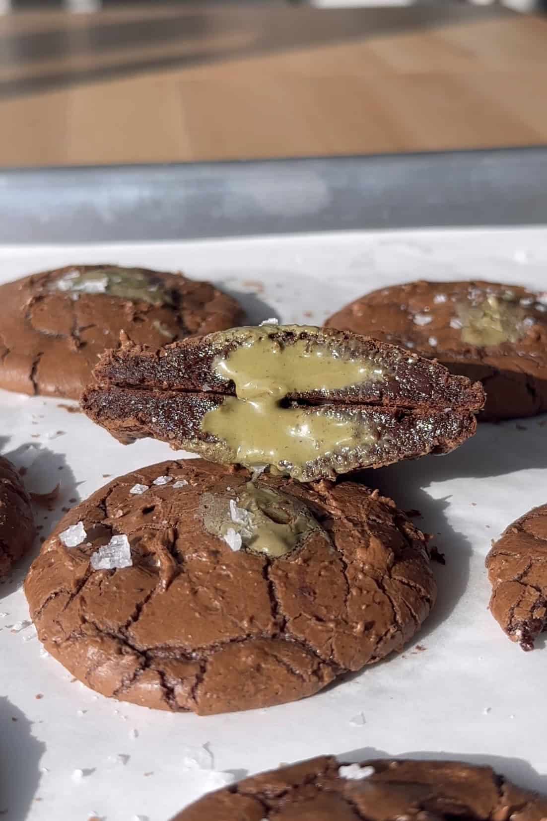 Pistachio Cream Stuffed Brownie Cookie cut in half.