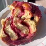 Roasted Raspberry Sweet Roll cut in half.