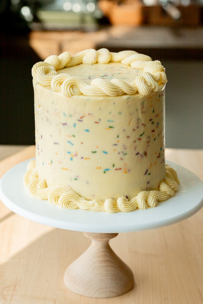 funfetti cake on cake stand.