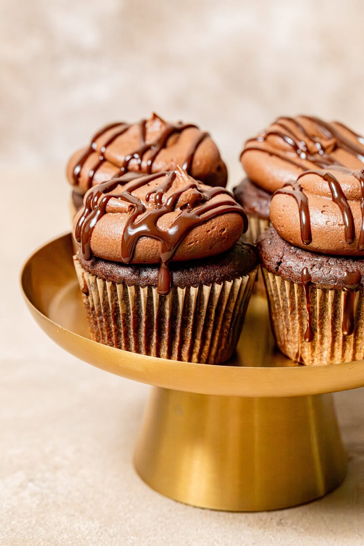 Chocolate Ganache Cupcakes on cake stand.