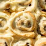 no knead cinnamon rolls with cream cheese frosting in pan.