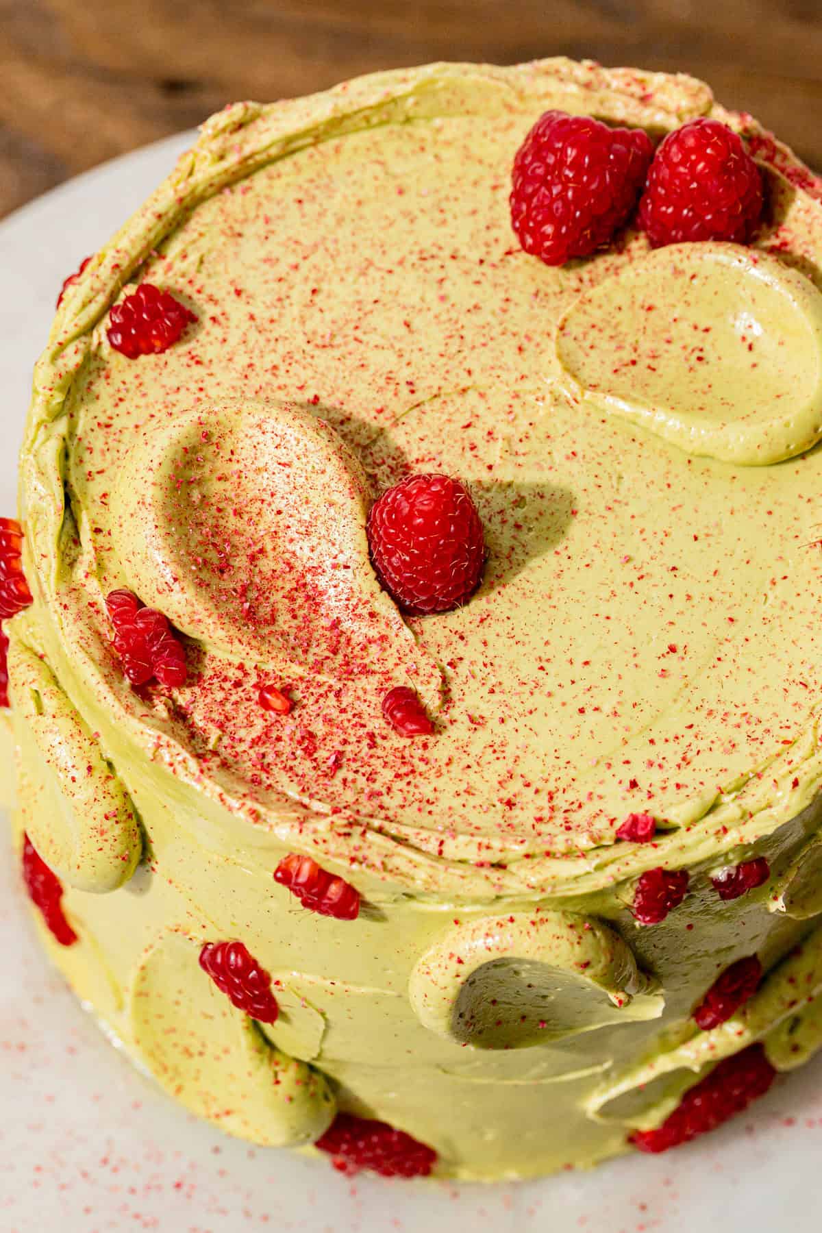 Pistachio Raspberry Cake on marble.