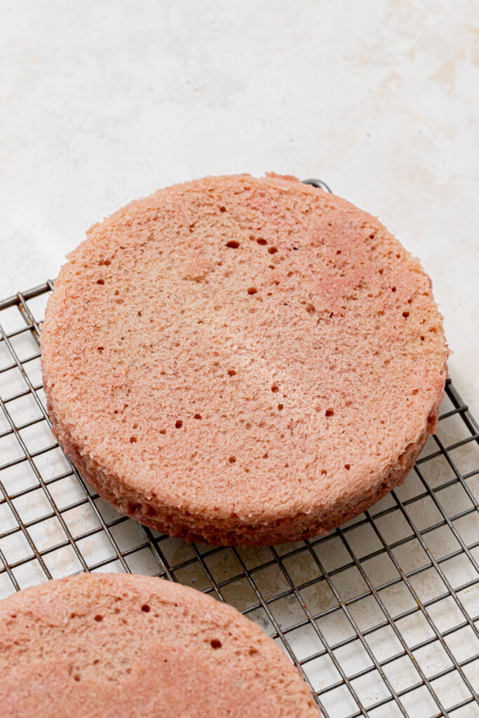 raspberry cake layers on wire rack.