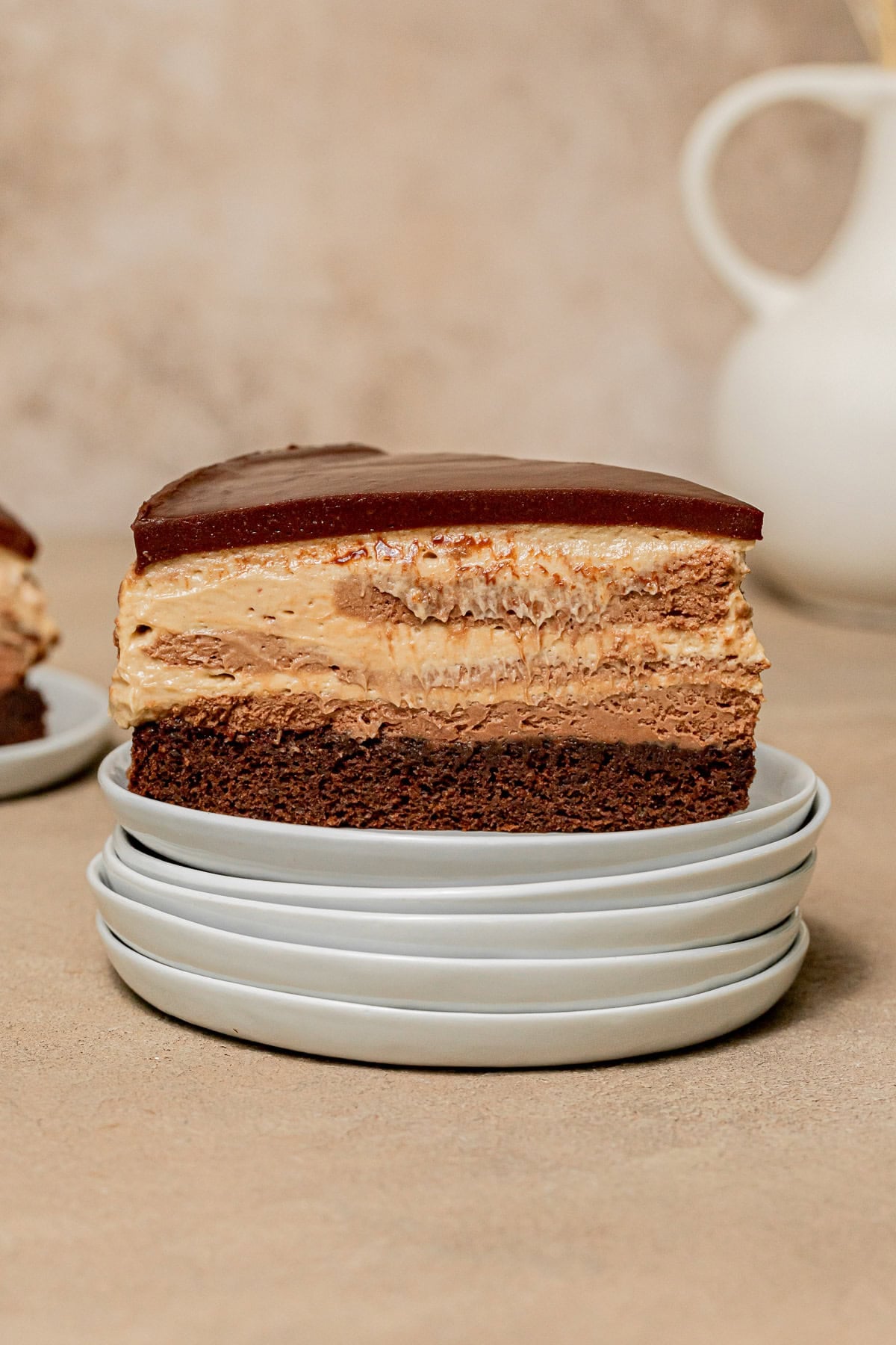 Chocolate Peanut Butter Mousse Cake slice on stacked plates.