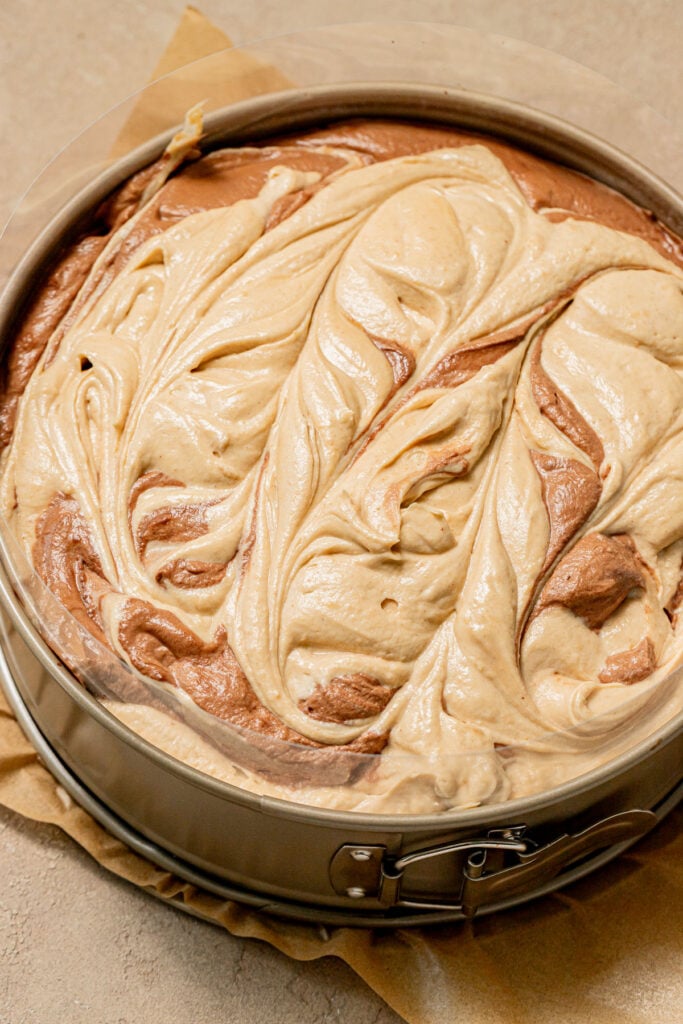 mousses added to cake in pan.