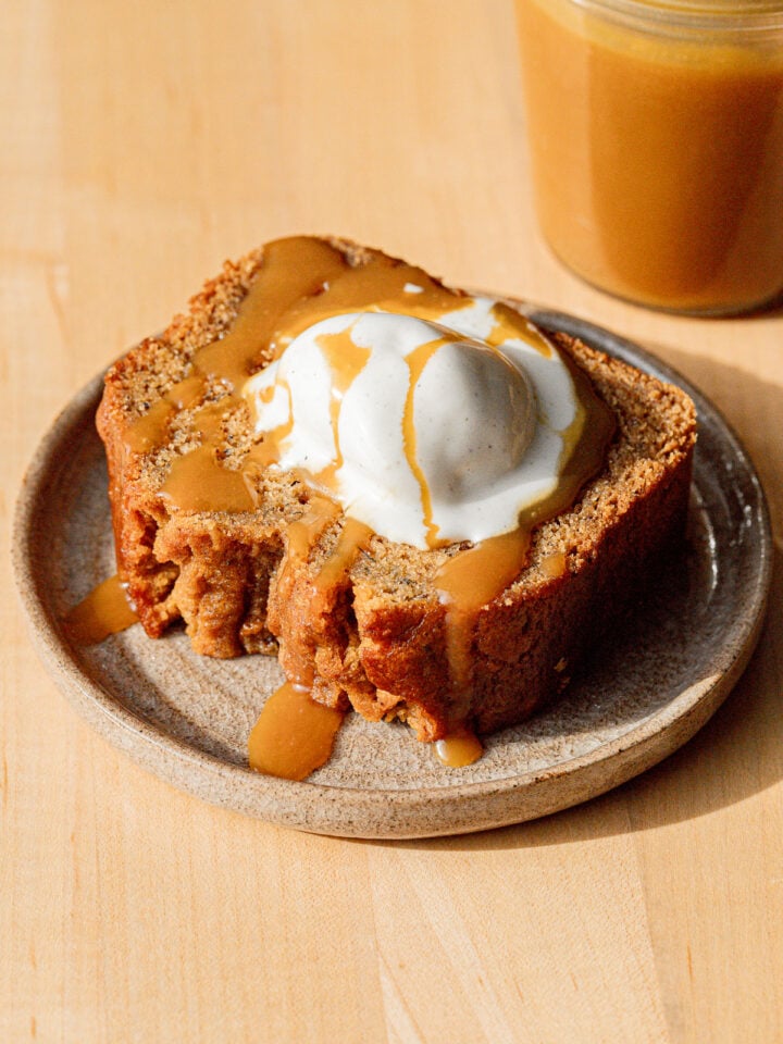 bourbon banana bread slice on plate with ice cream.