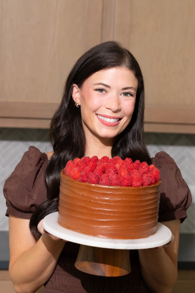 Sloane holding a cake.