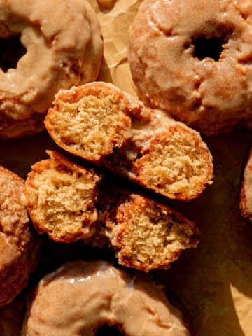 old fashioned banana bread donut cut in half on baking sheet.