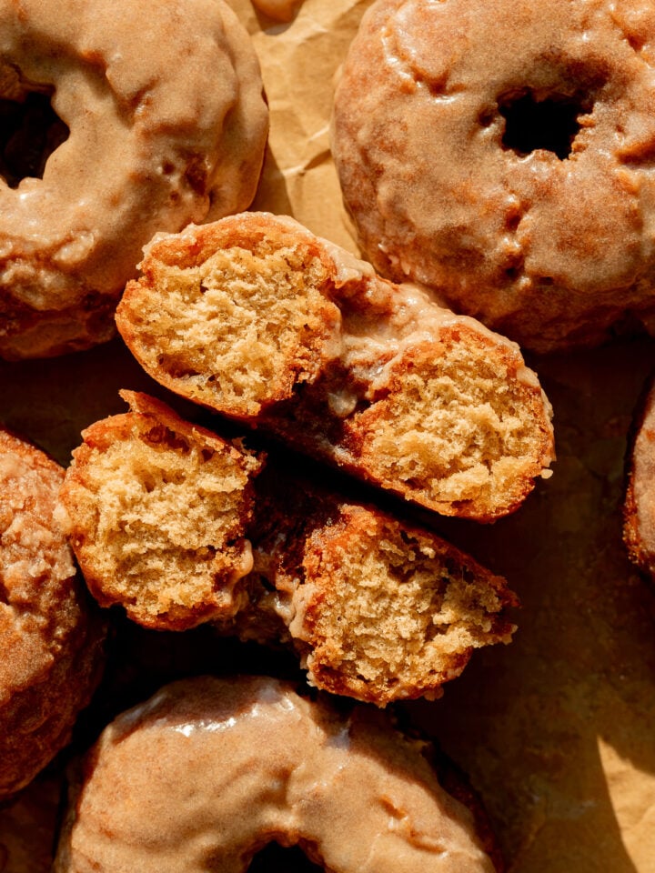 old fashioned banana bread donut cut in half on baking sheet.