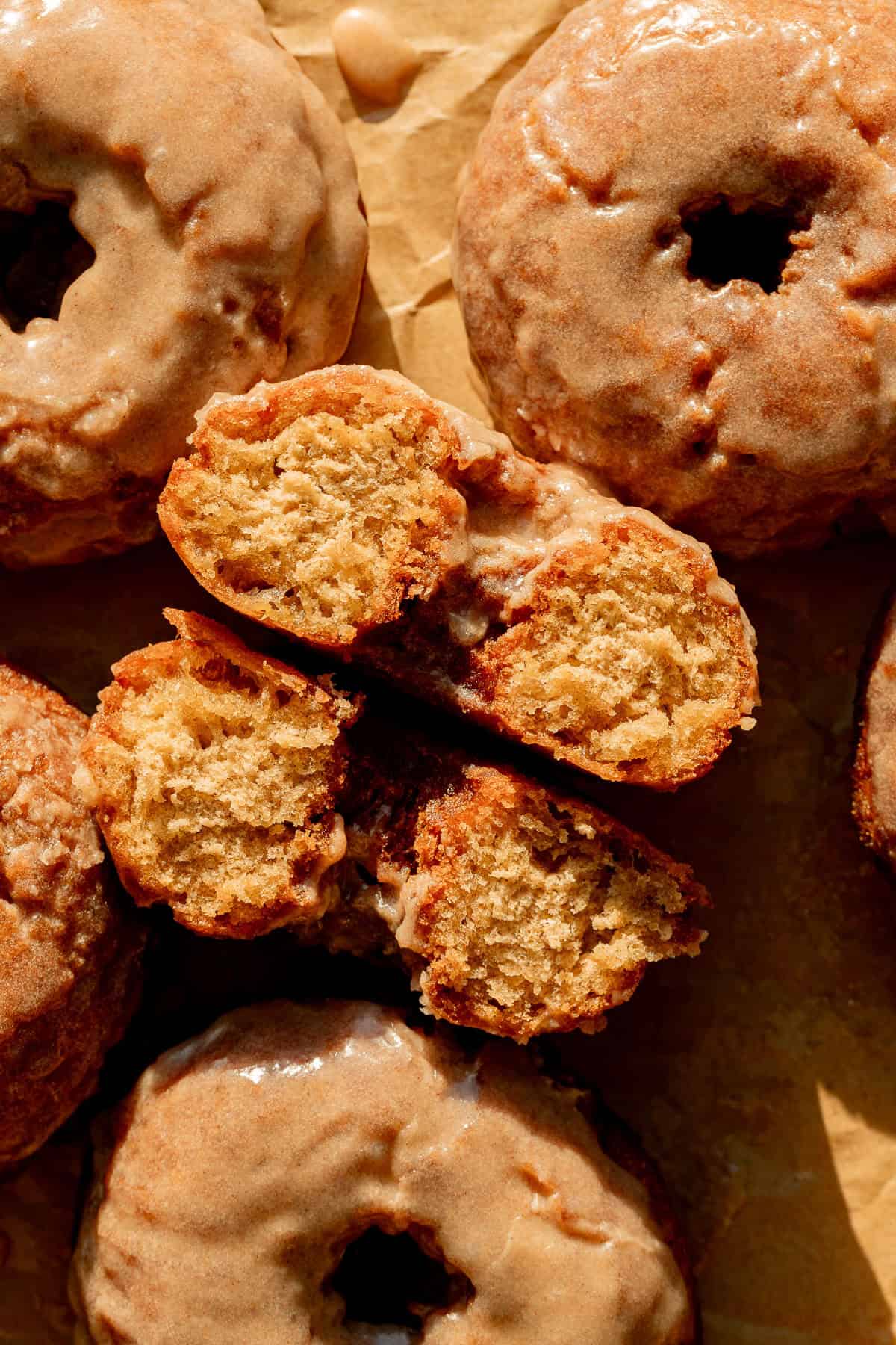 old fashioned banana bread donut cut in half on baking sheet.
