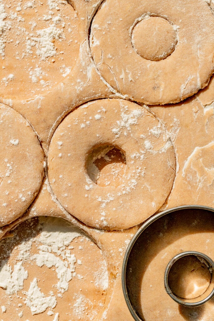 donut dough being cut out.